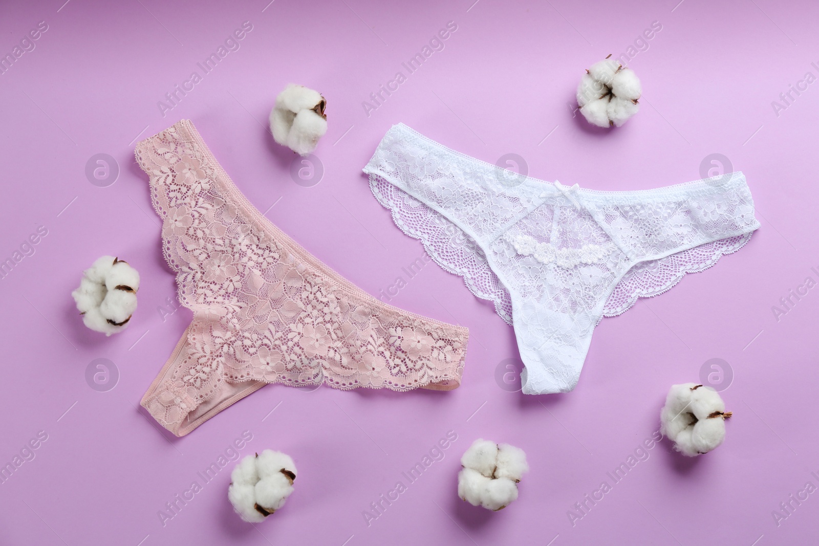 Photo of Women's underwear and cotton flowers on lilac background, flat lay