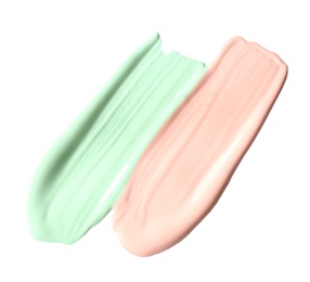 Photo of Strokes of different color correcting concealers isolated on white
