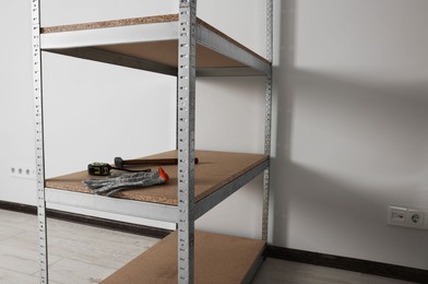 Metal storage shelf with room renovation tools in office