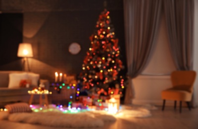 Photo of Blurred view of stylish room interior with decorated Christmas tree