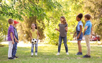 Photo of Cute little children playing with ball outdoors on sunny day