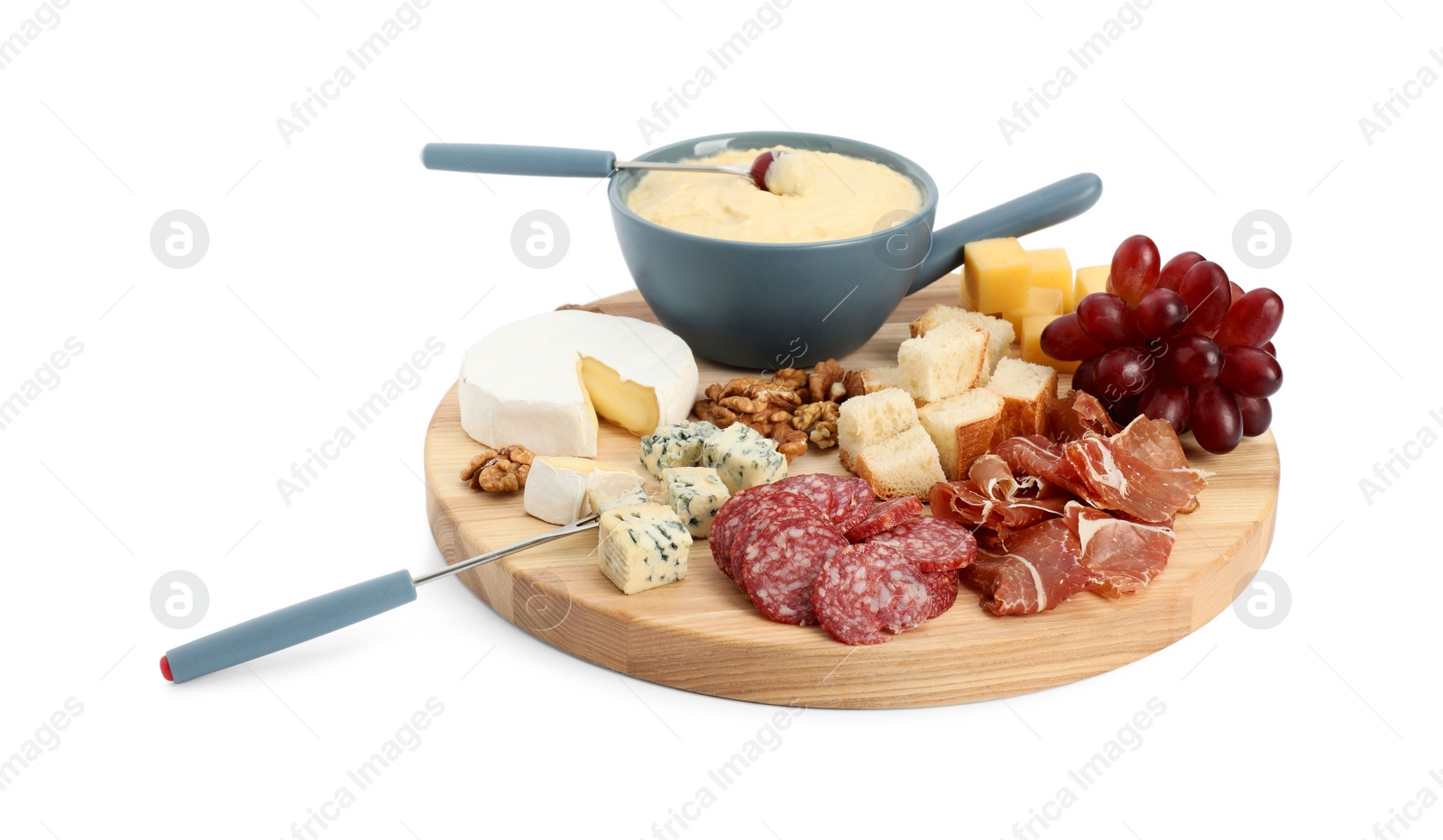 Photo of Fondue with tasty melted cheese, forks and different snacks isolated on white