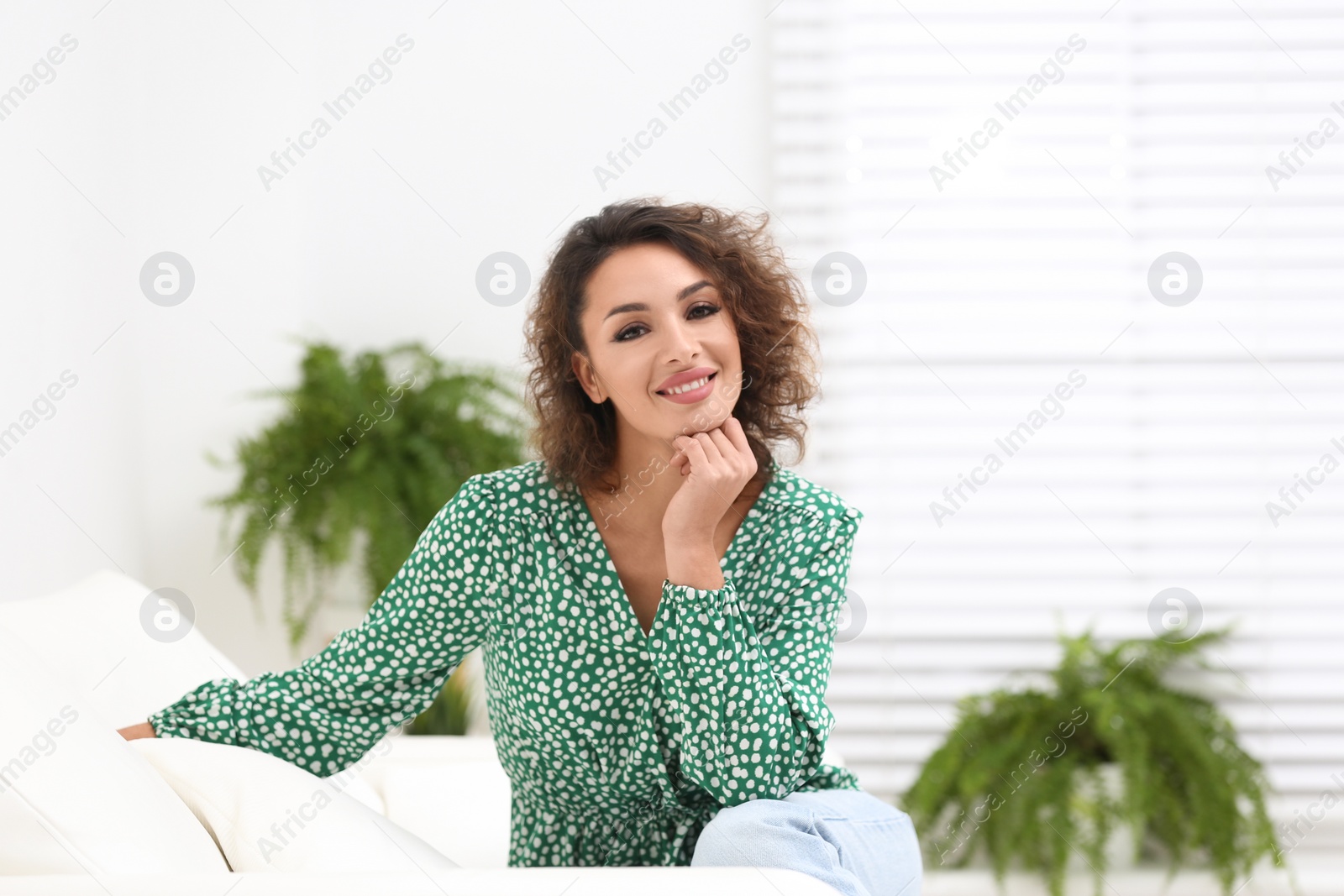 Photo of Beautiful woman in casual outfit on sofa indoors