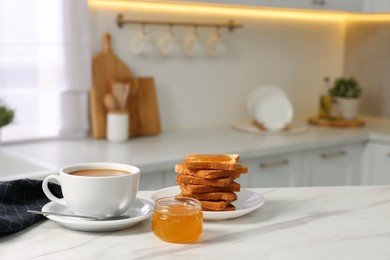 Photo of Breakfast served in kitchen. Fresh toasts, coffee and honey on white marble table. Space for text