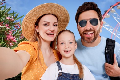 Image of Happy family with child taking selfie near observation wheel outdoors