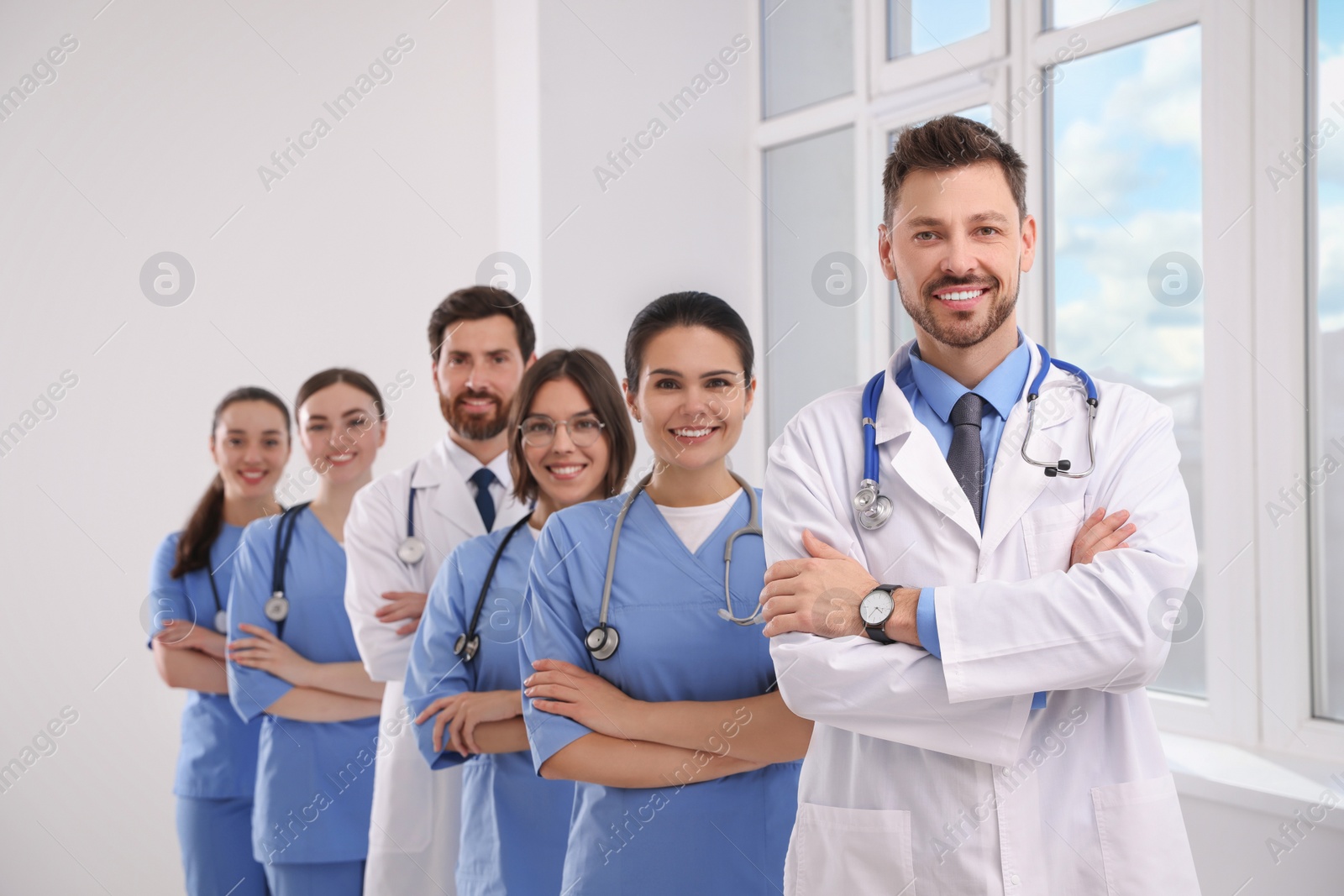 Photo of Team of professional doctors in clinic hallway