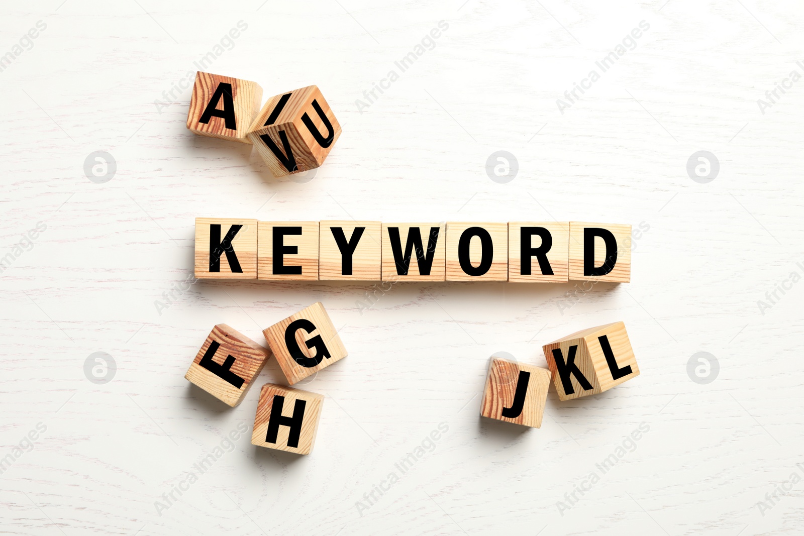 Photo of Cubes with word KEYWORD on white wooden background, flat lay