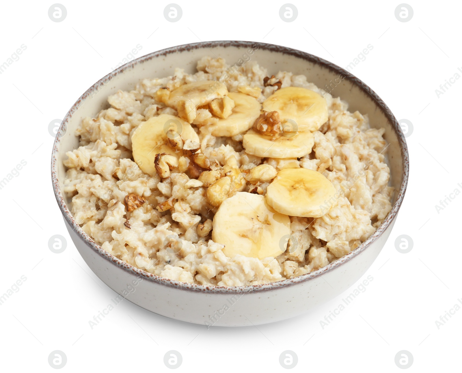 Photo of Tasty oatmeal with banana and walnuts in bowl isolated on white