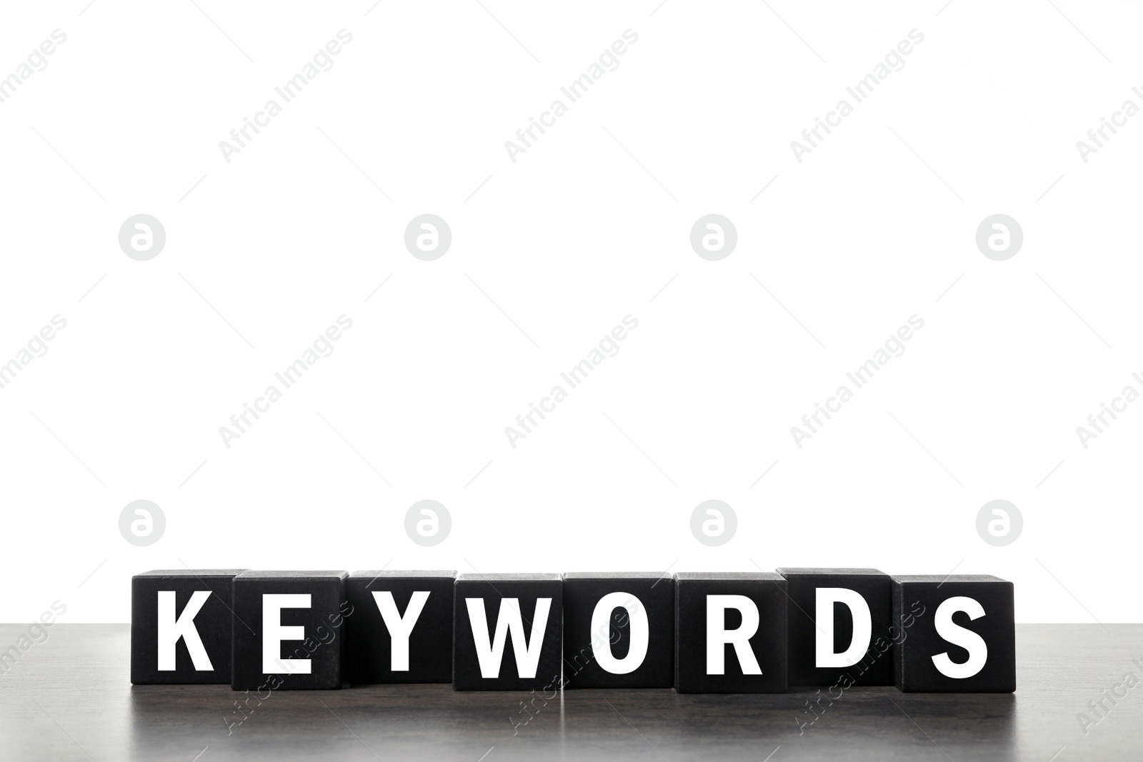 Photo of Black cubes with word KEYWORDS on white background