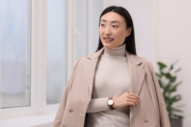 Portrait of smiling confident businesswoman in office