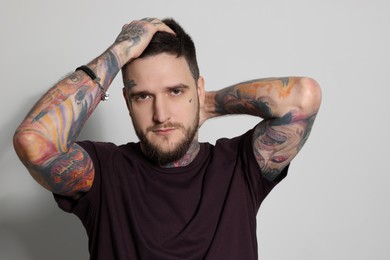Photo of Handsome hipster man posing on light grey background