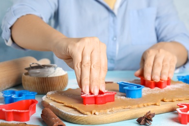 Photo of Woman making Christmas cookies at table, closeup