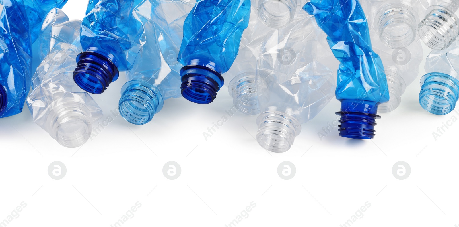 Photo of Crumpled disposable plastic bottles on white background, space for text