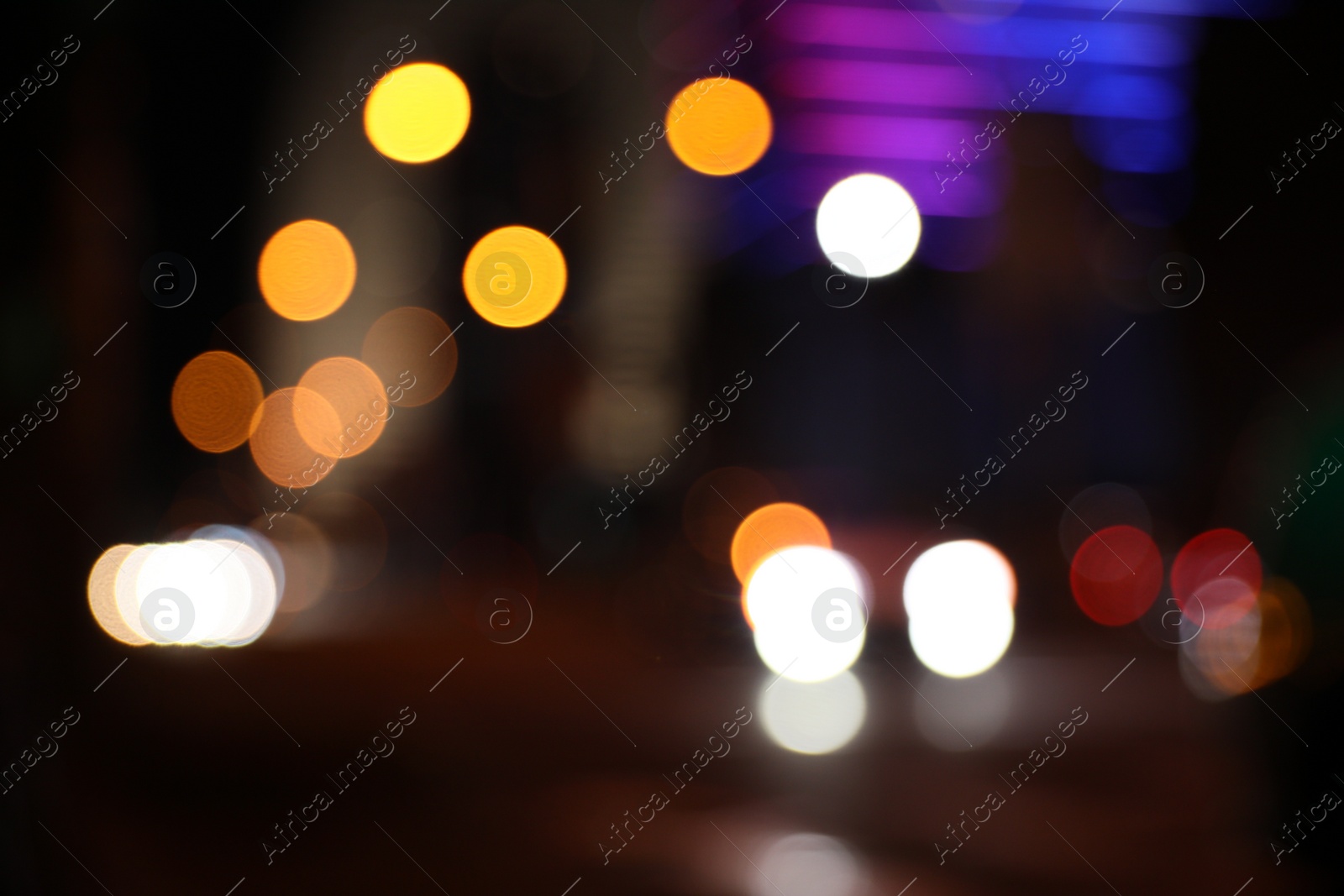 Photo of Blurred view of cityscape with bokeh effect. Night life