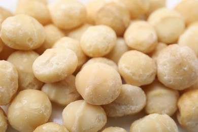Photo of Tasty peeled Macadamia nuts as background, closeup