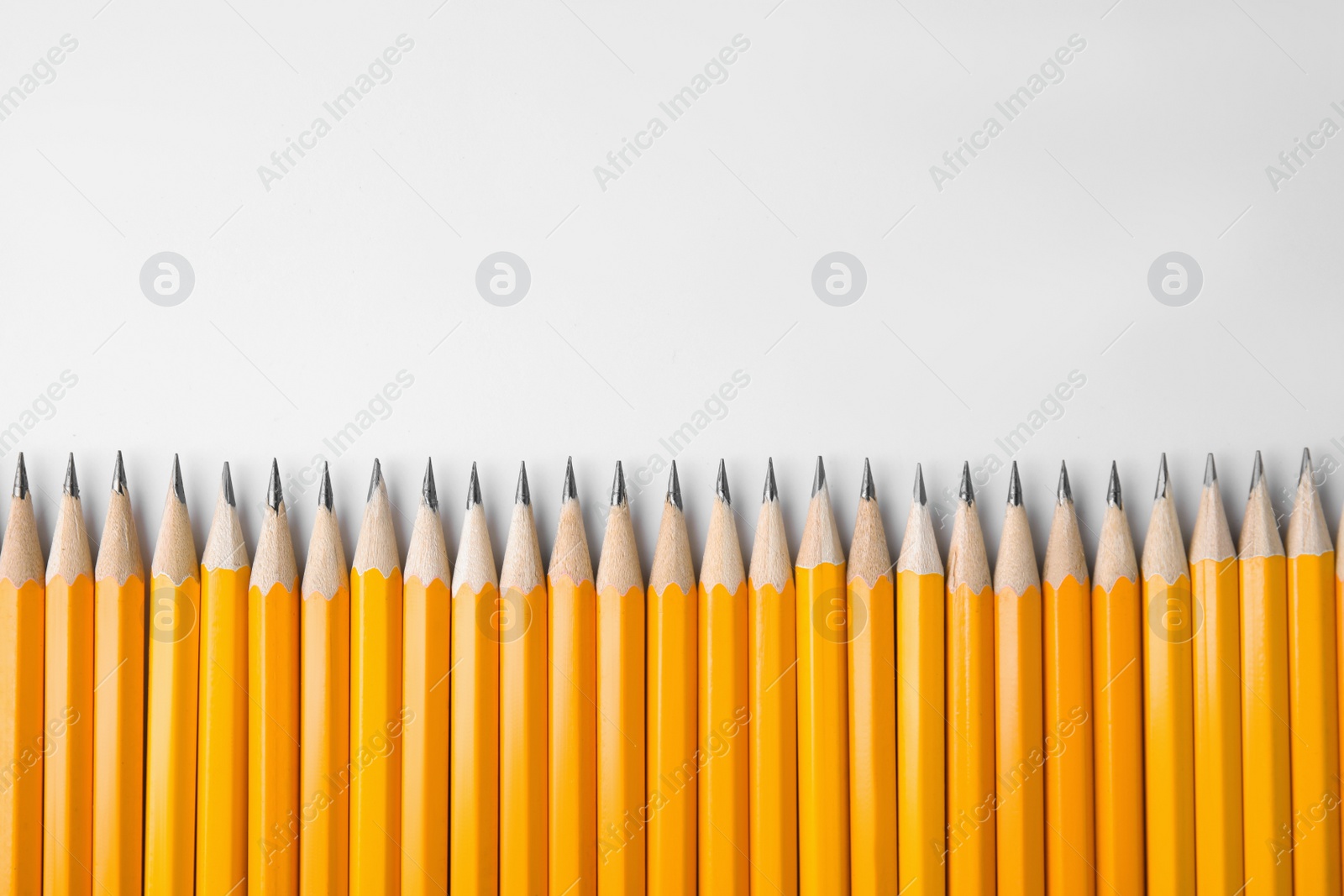 Photo of Graphite pencils on white background, top view. Space for text