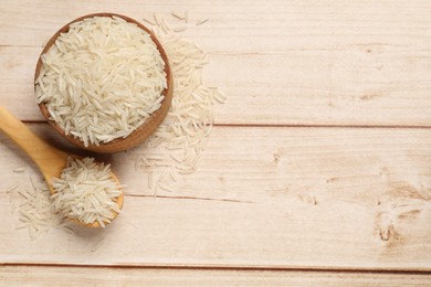 Photo of Raw basmati rice on white wooden table, flat lay. Space for text