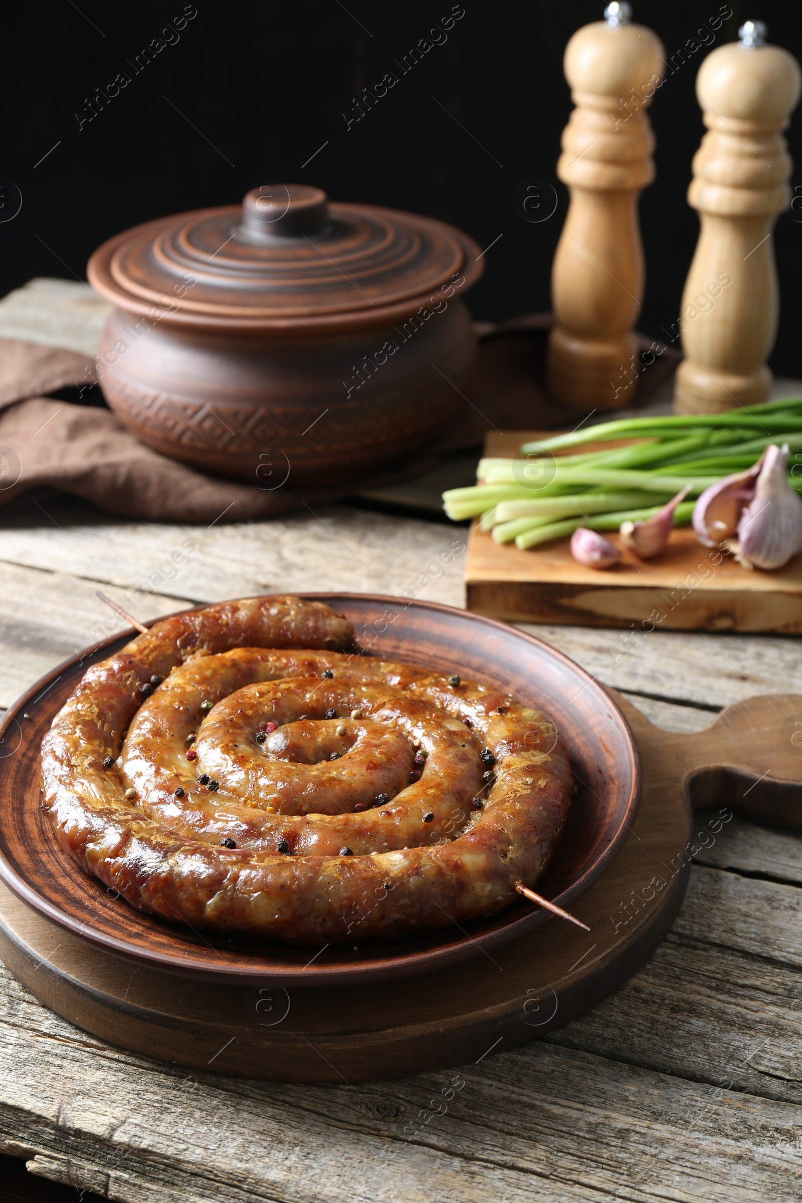 Photo of Plate with tasty homemade sausages on wooden table