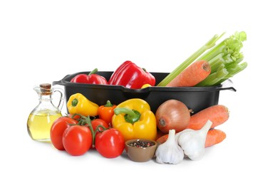 Photo of Black pot and pile of fresh products isolated on white