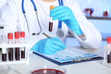 Photo of Female scientist working at table in laboratory. Research and analysis