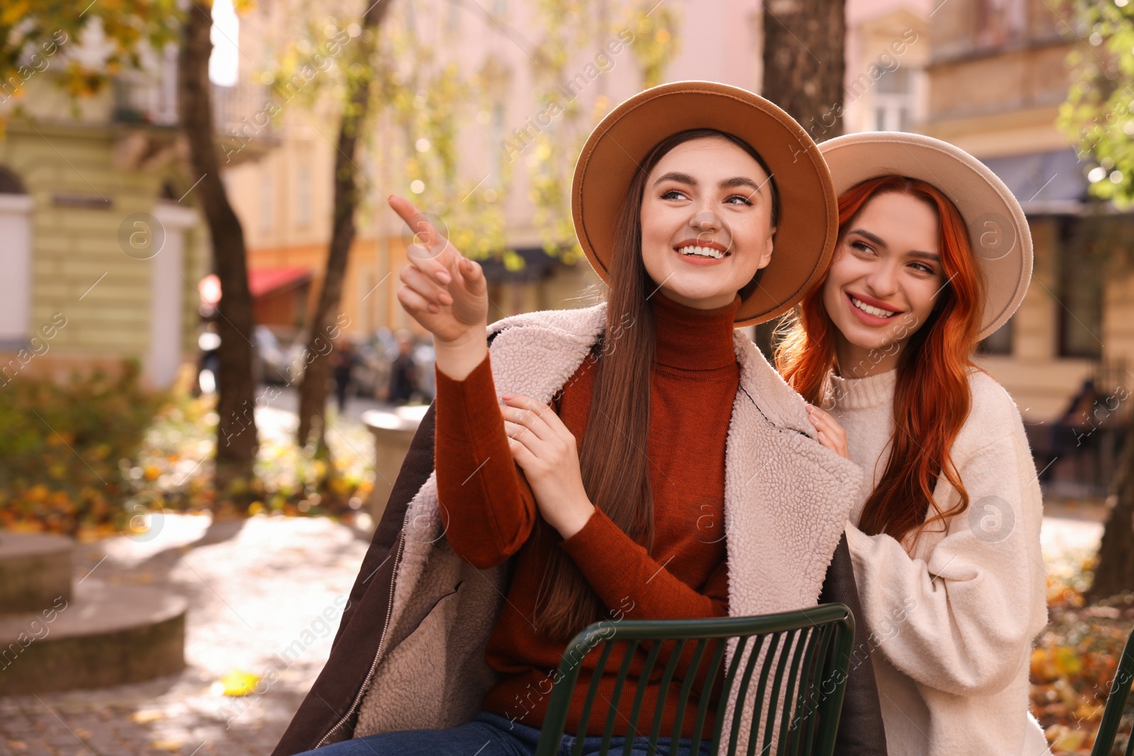 Photo of Happy friends spending time together outdoors on autumn day