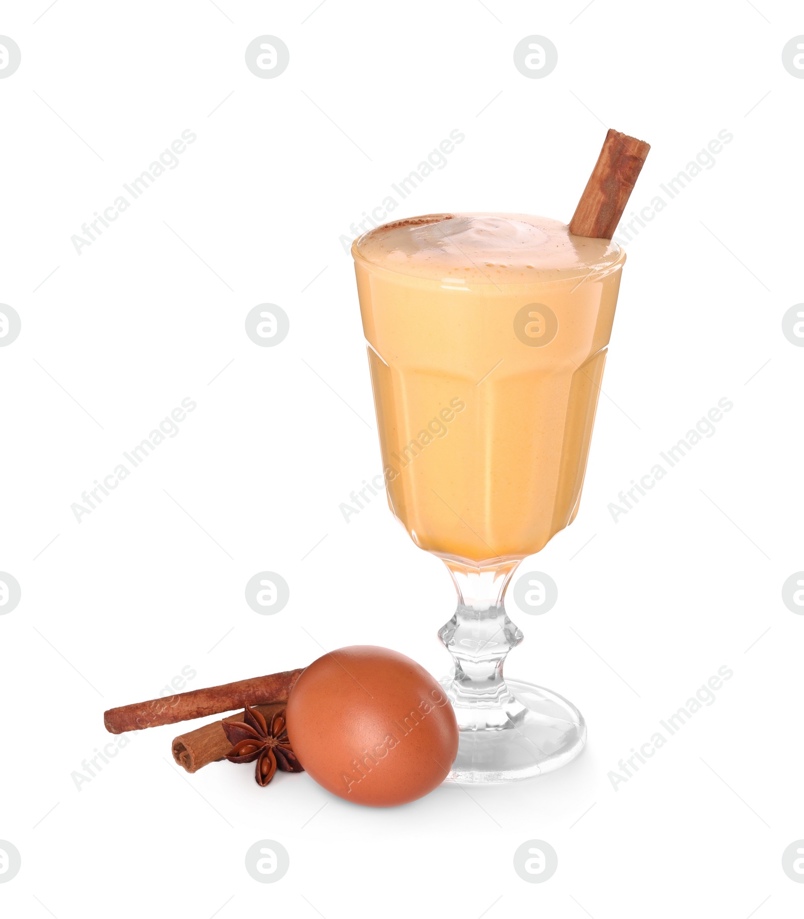 Photo of Delicious eggnog in glass, spices and egg isolated on white