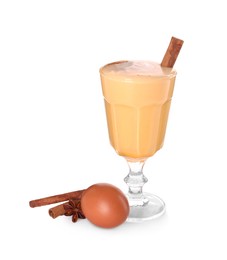 Photo of Delicious eggnog in glass, spices and egg isolated on white