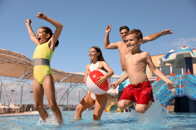 Happy family having fun at water park. Summer vacation