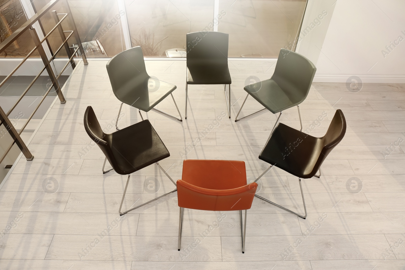 Photo of Chairs prepared for group therapy session in office. Meeting room interior