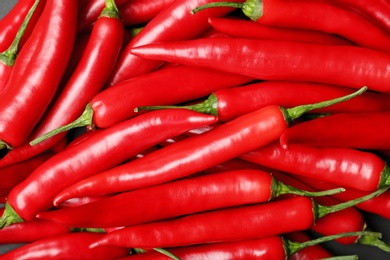 Ripe hot chili peppers as background, closeup