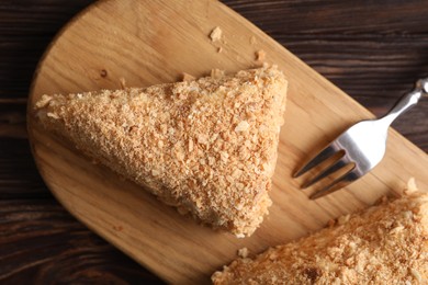 Pieces of delicious Napoleon cake served on table, top view