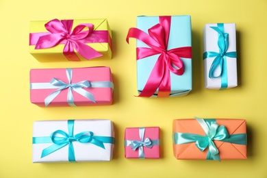 Photo of Flat lay composition with beautiful gift boxes on color background