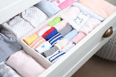 Photo of Wardrobe drawer with many child socks, closeup