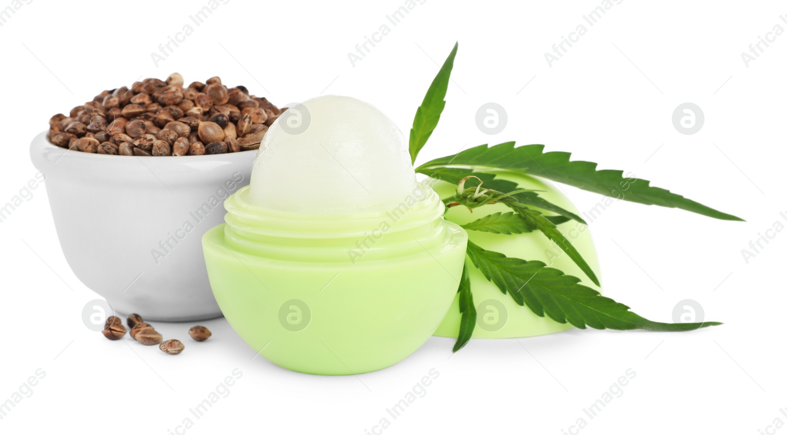 Photo of Hemp lip balm, seeds and green leaves on white background. Natural cosmetics