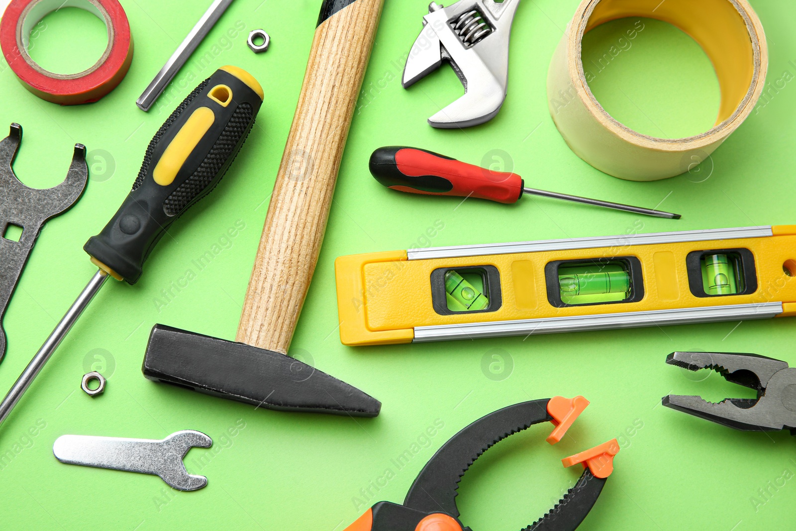 Photo of Set of repair tools on light green background, flat lay