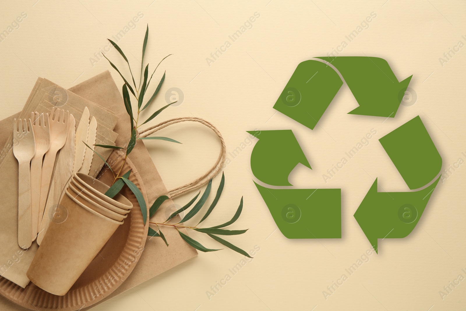 Image of Flat lay composition with eco friendly products and recycling symbol on beige background