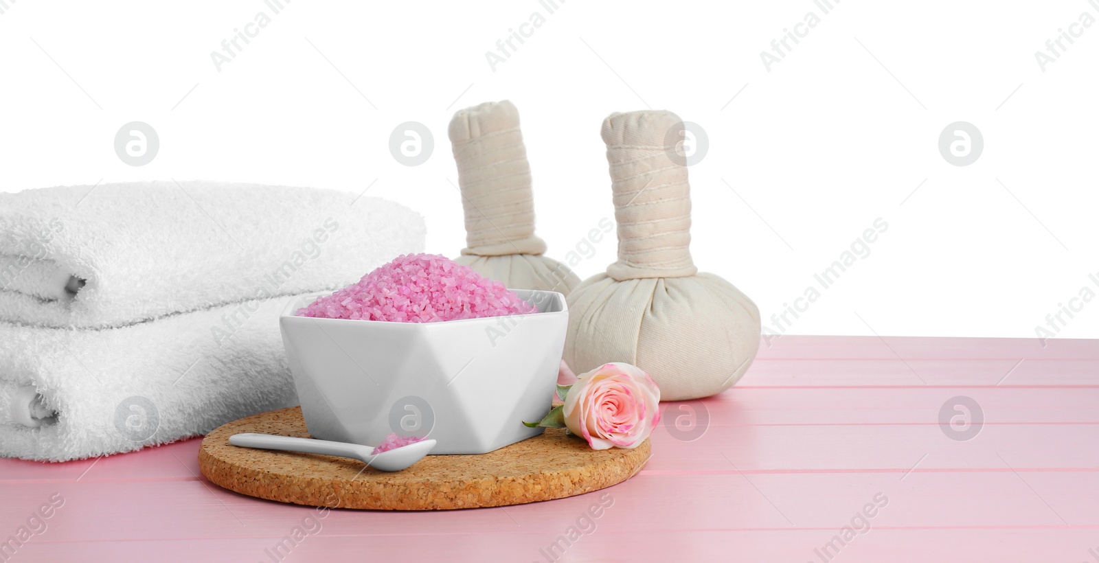 Photo of Composition with sea salt and herbal bags on pink wooden table against white background