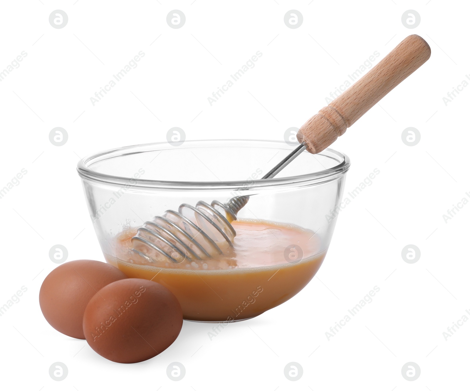 Photo of Beaten eggs and whisk in glass bowl isolated on white