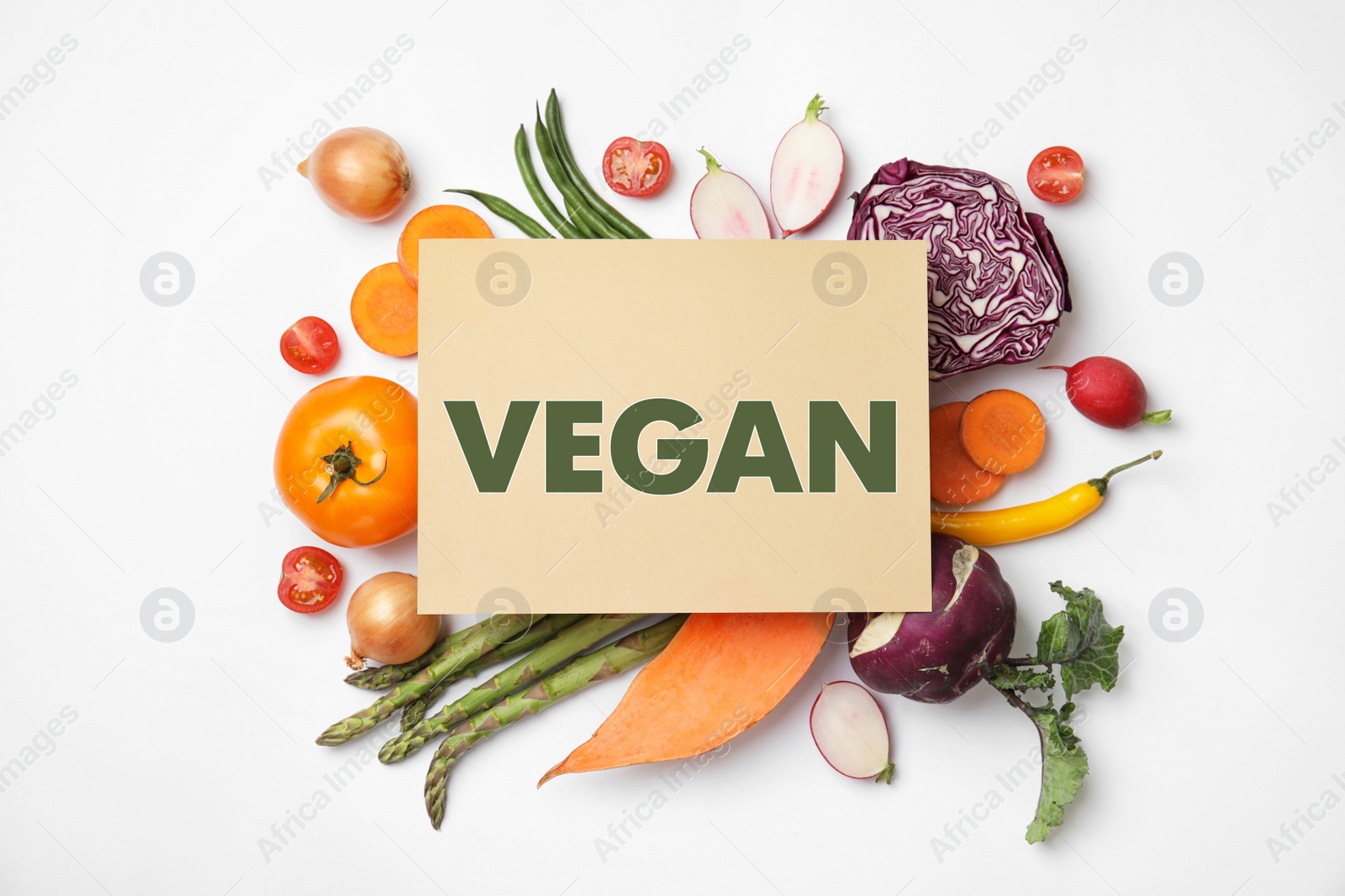 Image of Paper card with word Vegan and fresh vegetables on white background, flat lay