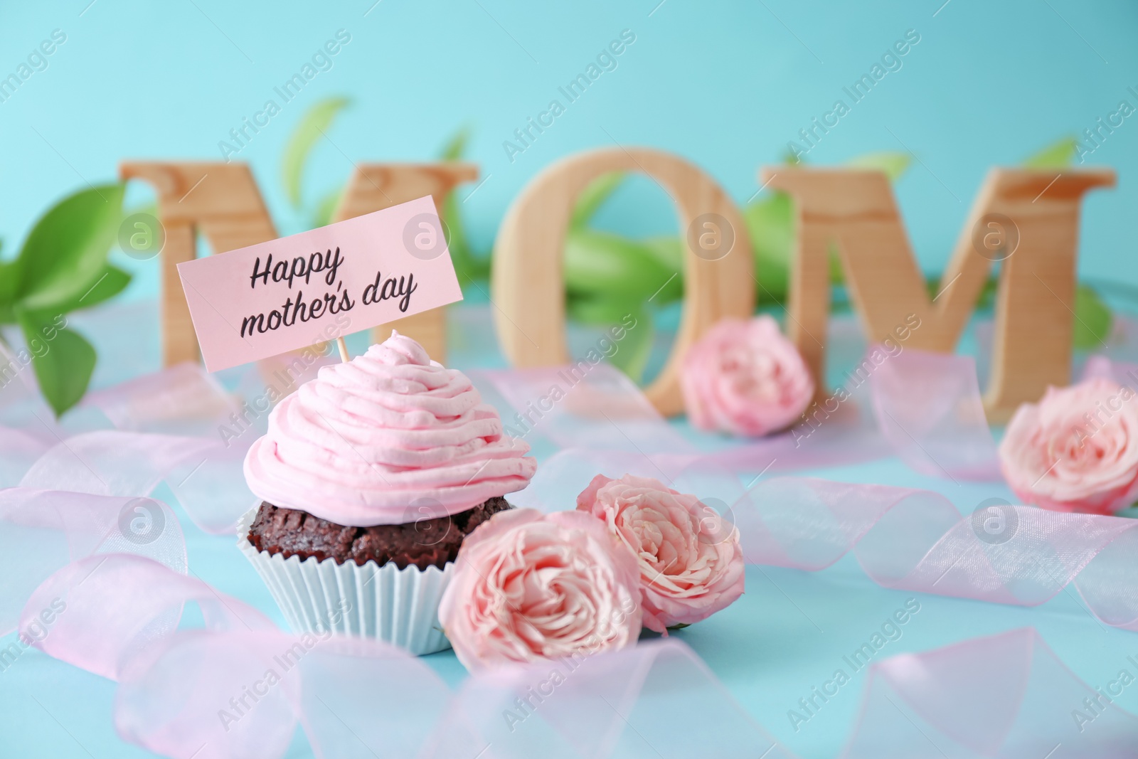 Photo of Festive surprise with tasty treat for Mother's Day on color background