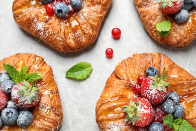 Photo of Fresh delicious puff pastry with sweet berries on light background, flat lay