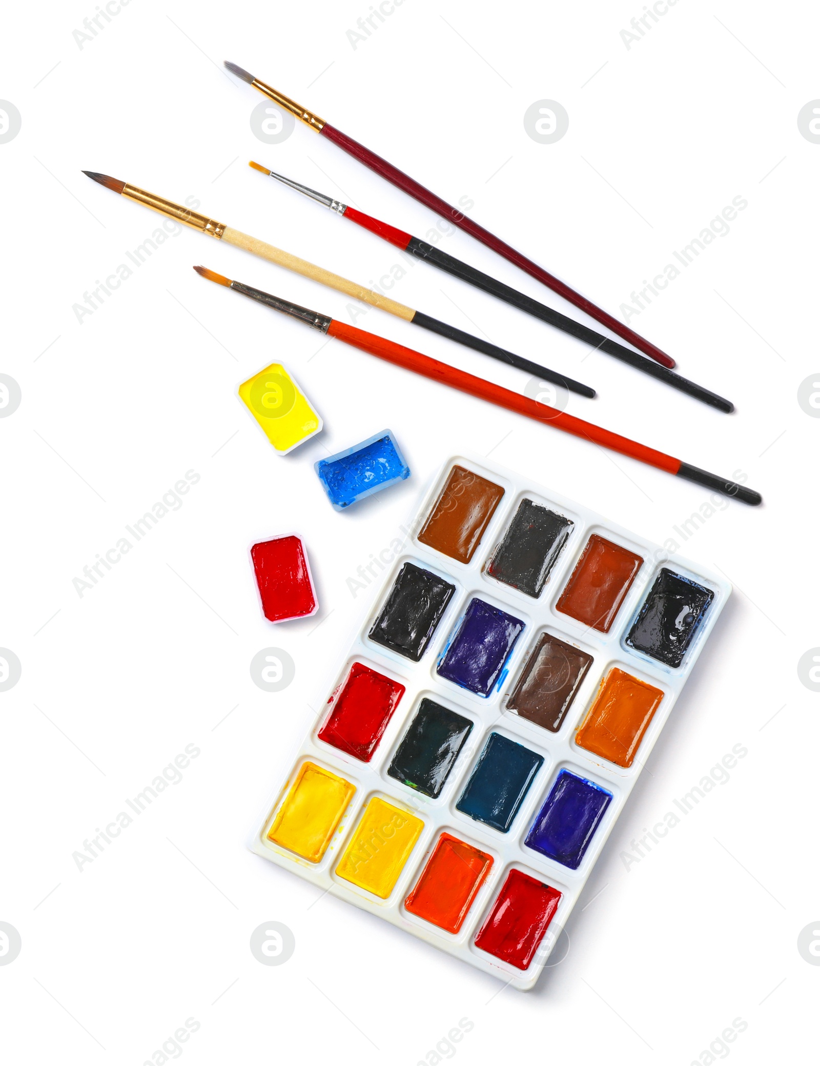 Photo of Plastic palette with colorful paints and brushes on light background, top view