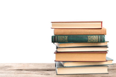 Photo of Stack of old vintage books on wooden table against white background