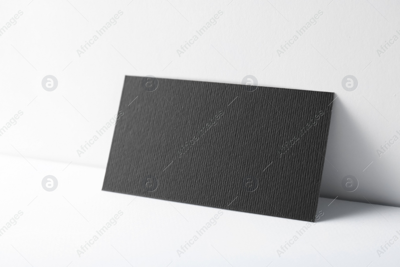 Photo of Blank black business card on white background. Mockup for design