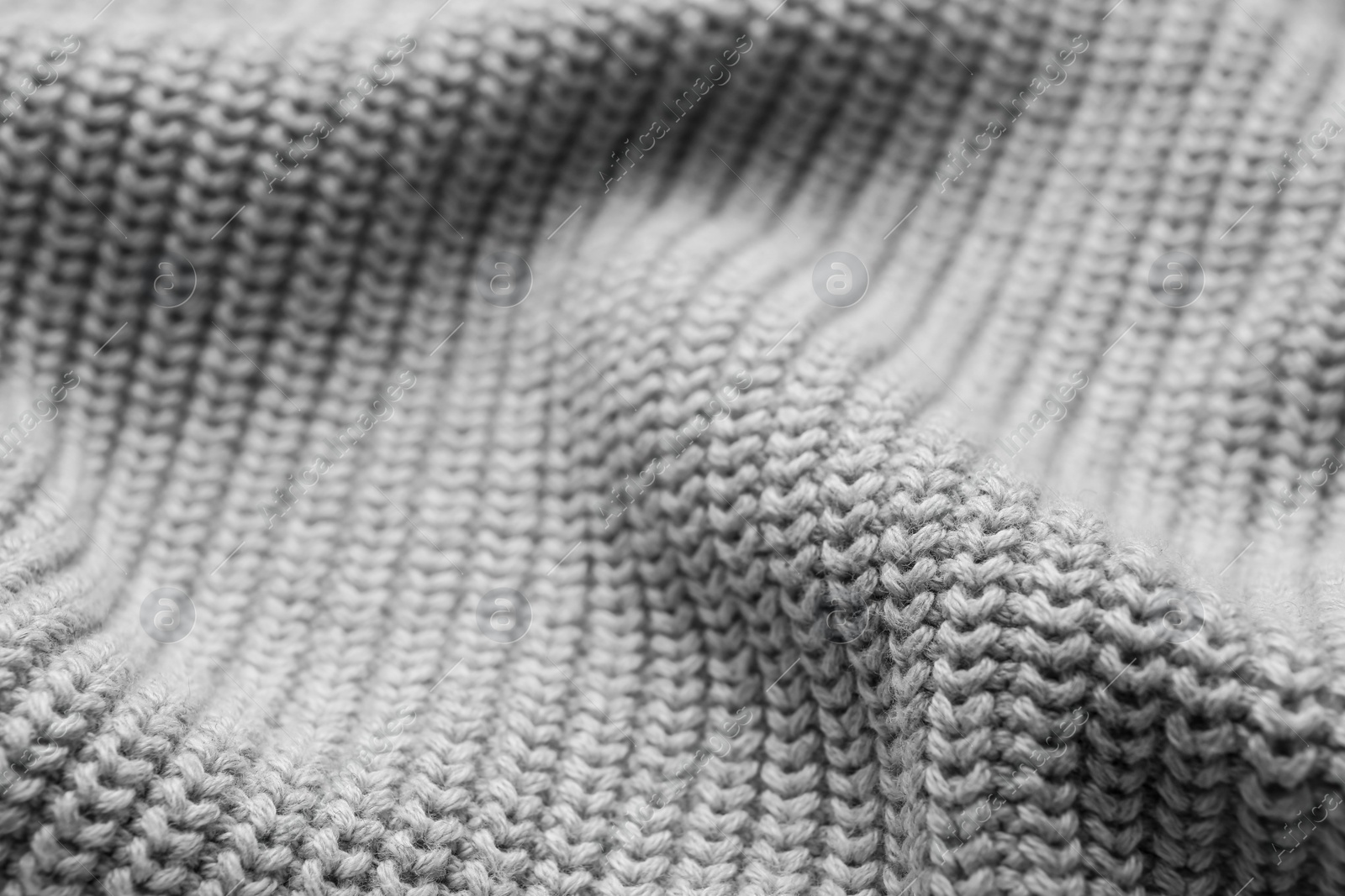 Photo of Grey knitted fabric as background, closeup view