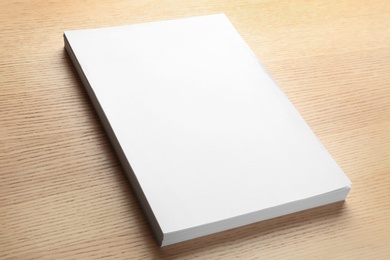 Photo of Stack of blank paper sheets for brochure on wooden background. Mock up