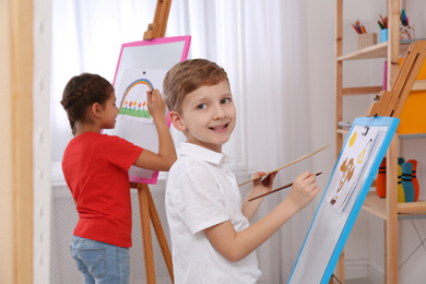Cute little children painting during lesson in room