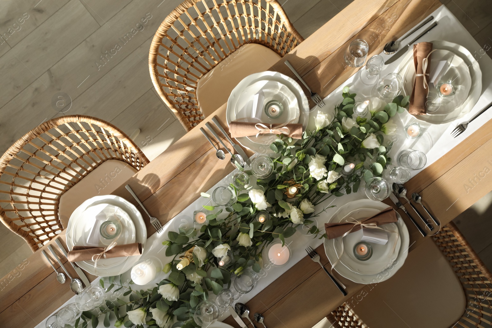 Photo of Elegant table setting with beautiful floral decor and burning candles, top view