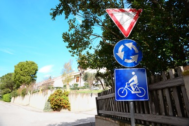Photo of Different traffic signs on city street, space for text