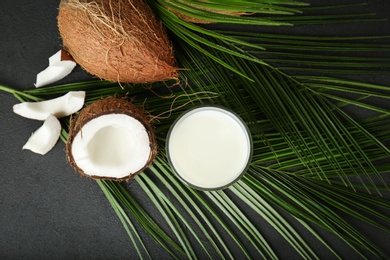 Glass of coconut milk on dark background, top view